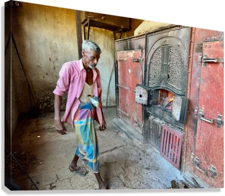 Man Fuelling Up the Fire Canvas Print